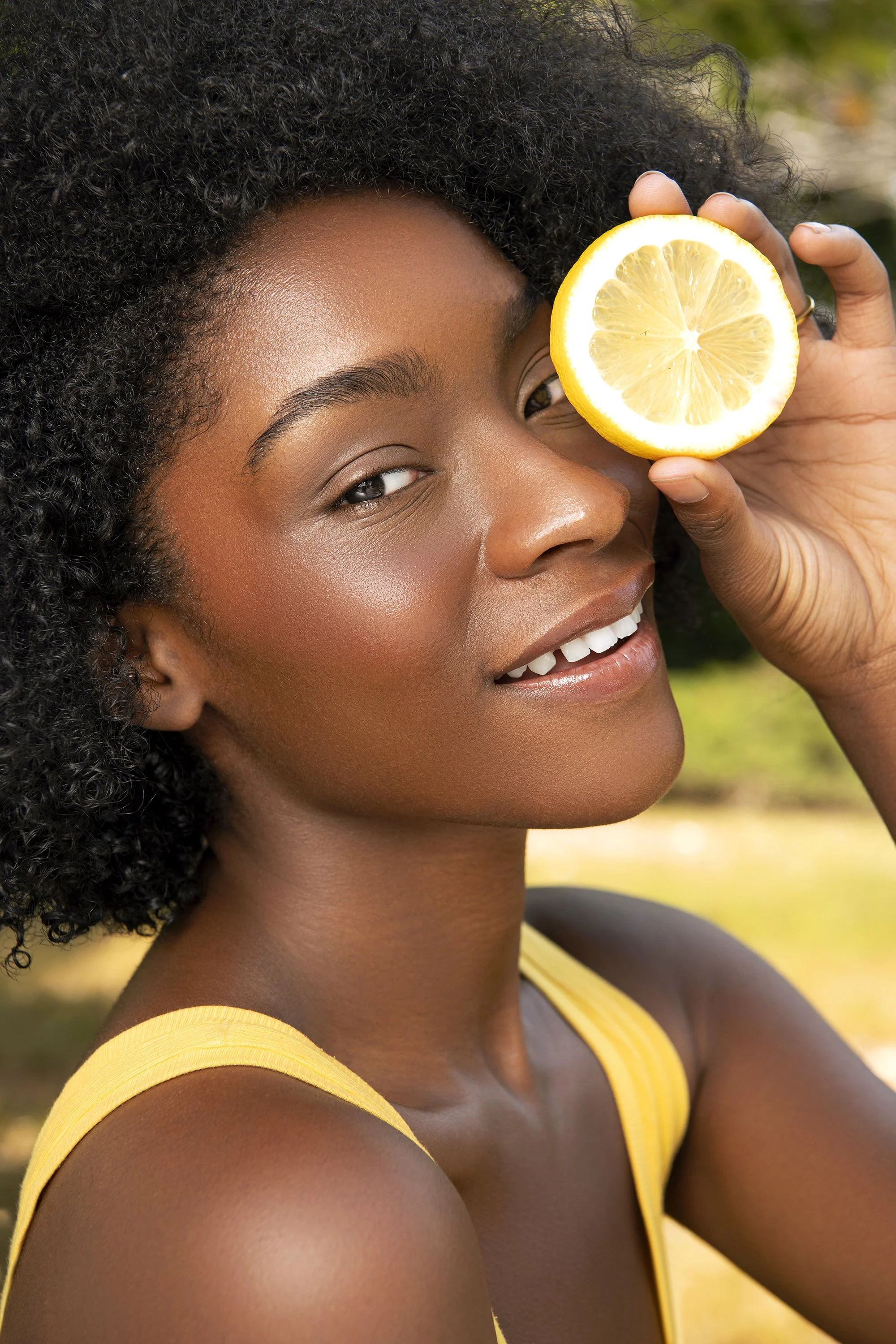 Commercial beauty campaign imagery of Forward The Agency model Olivia photographed outdoors in Atlanta, Georgia, showcasing makeup artistry, natural skin texture, colorful styling, and bright summer beauty photography.