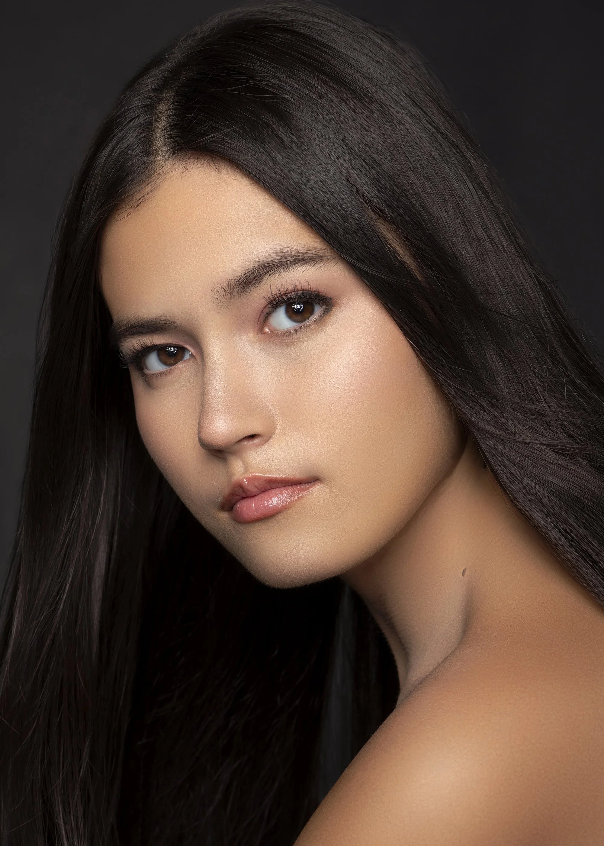 Luxury beauty portrait of a professional model from Forward The Agency photographed in studio at Industry Makeup Academy in Atlanta, Georgia. Black background beauty photography highlighting flawless skin, bold editorial makeup, and precision studio 