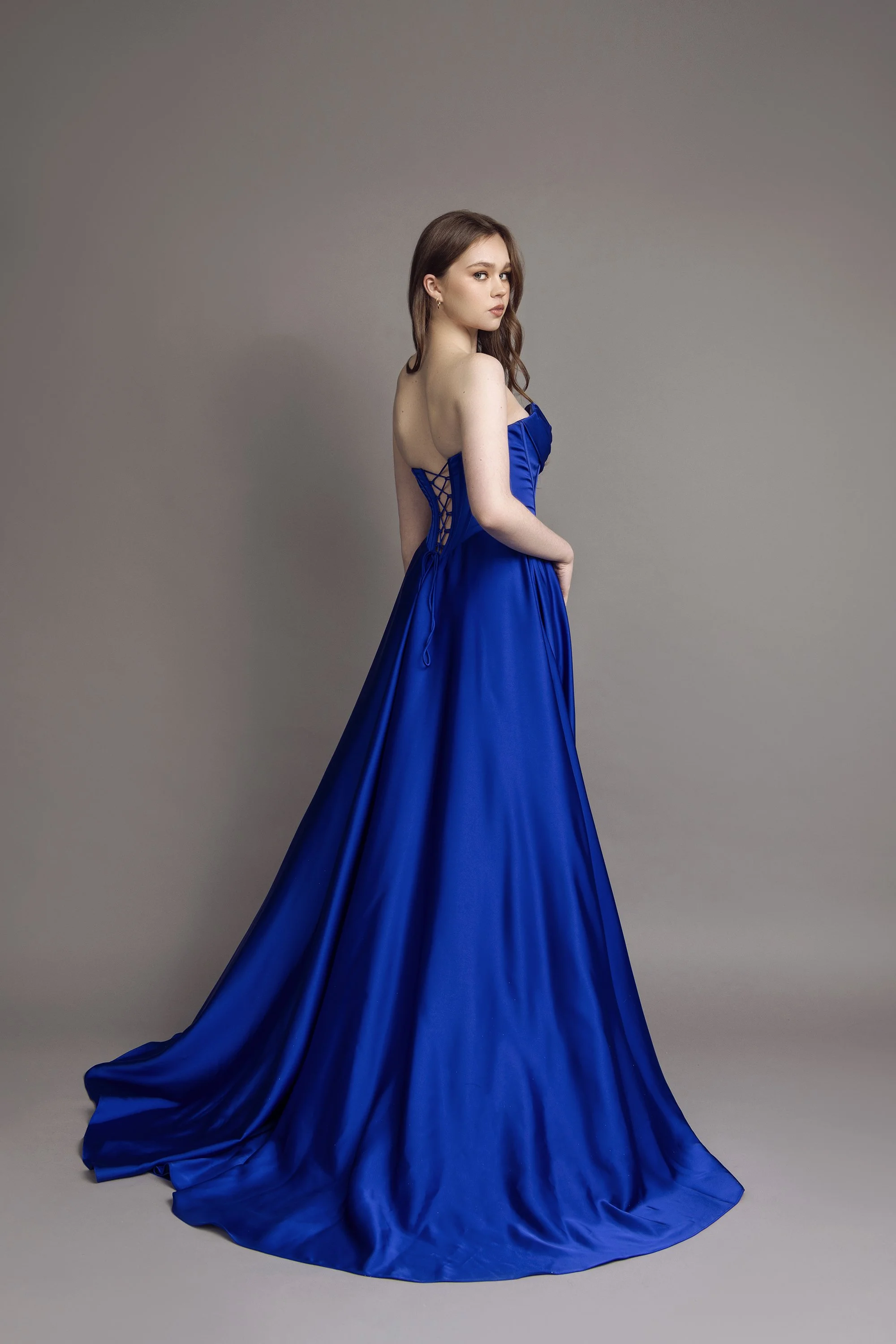 Atlanta portrait photographer Caitlin Tabilog captures beauty and fashion model in studio with dramatic editorial lighting wearing gown from Twin Hearts Formal Canton Georgia