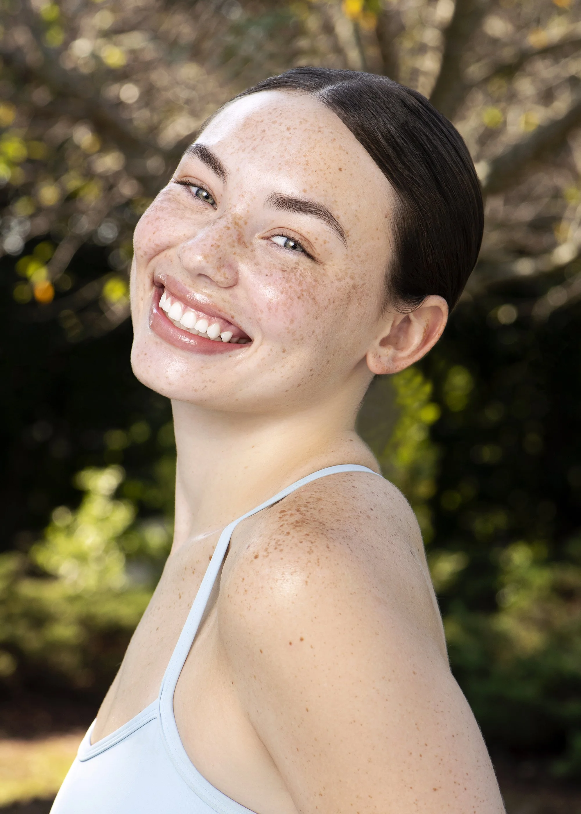 Atlanta beauty photographer Caitlin Tabilog captures a natural-light beauty portrait of Forward The Agency model Gracie featuring colorful makeup, healthy-looking skin, summer fashion, and professional beauty styling by Danielle Onesto.