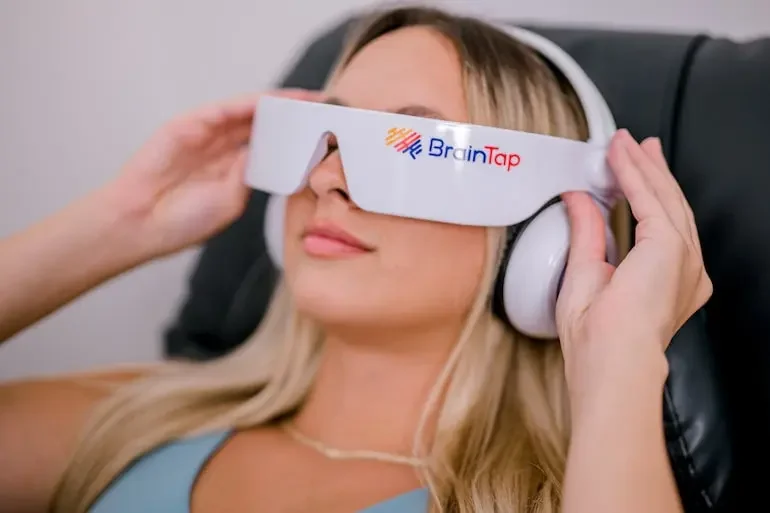 Woman using braintap therapy to relax