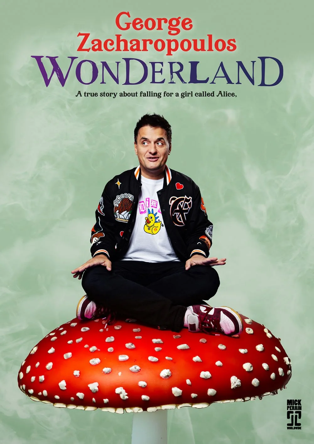 Cover of the book 'Wonderland' by George Zacharopoulos, featuring a man sitting cross-legged on a large red mushroom with white spots, wearing a black jacket with patches, a white t-shirt with cartoon characters, and sneakers, against a green backgro