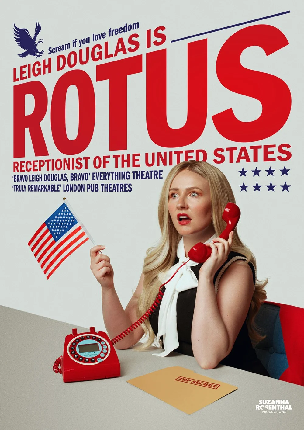 A woman with long blonde hair sitting at a desk, holding a red telephone receiver to her ear with her right hand and a small American flag in her left hand. She looks surprised or shocked. On the desk is a red rotary phone and a manila folder labeled