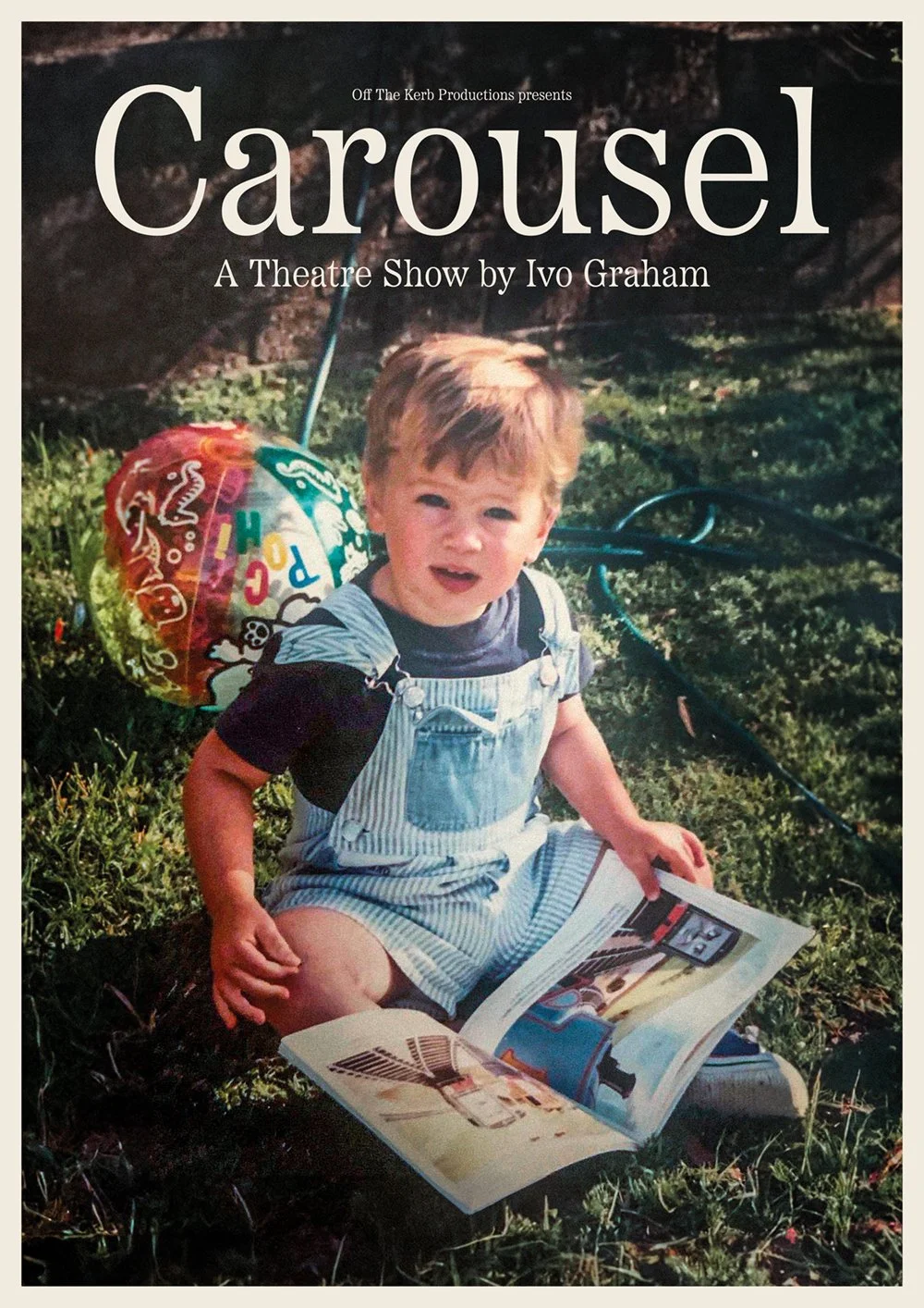 Cover of the theatre show 'Carousel' by Ivo Graham, featuring a young boy sitting on grass, reading a magazine, with a colorful balloon nearby.