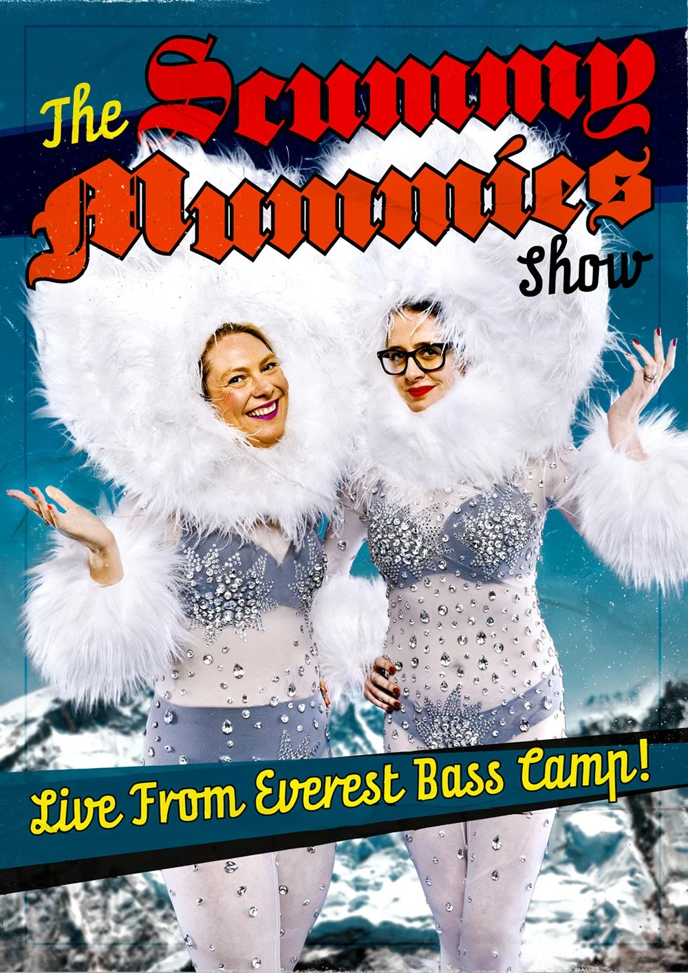 Two women in glamorous, rhinestone-studded costumes with large white feathered hoods, posing playfully against a snowy mountain backdrop, promoting a show live from Everest Base Camp.