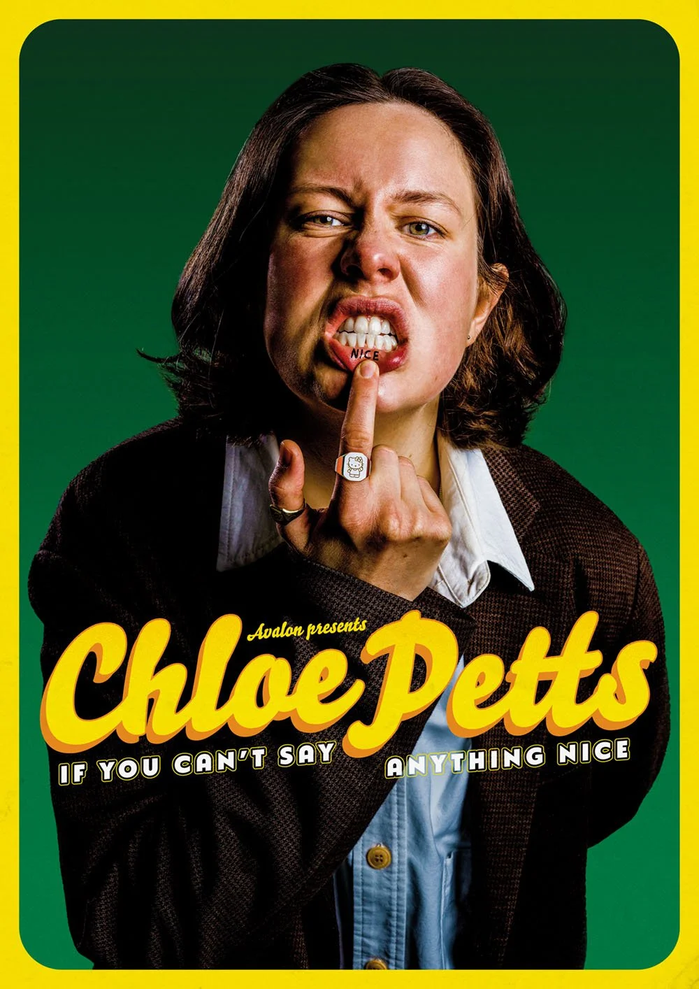 A woman with shoulder-length brown hair making a grimace while holding her finger to her lips, with the word 'NICE' written on her lower lip, against a green background, with yellow border, and promotional text for a show called 'Chloe Petts'.
