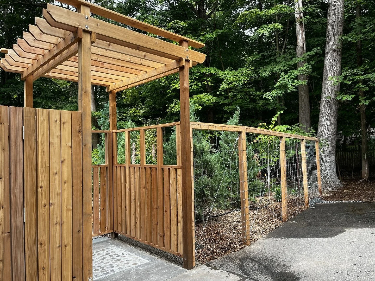 Rooted in this land, this new garden entry is. Not ornament, no. A scaffold of life, it shall be. Wood and stone, gathered near, serve not as display&hellip; but as host for succession, they will. The earthen berm&mdash;evergreens upon it planted&mda