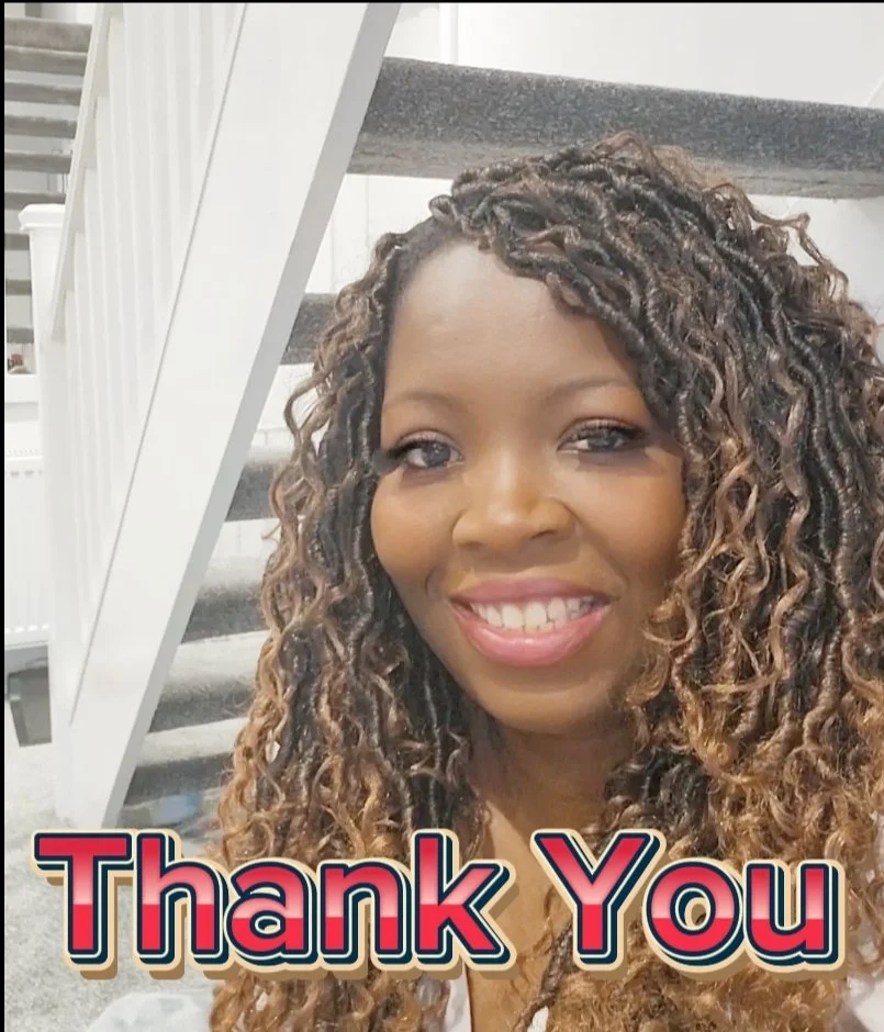 Close-up of a smiling woman with curly, brown and blonde hair, standing in front of a staircase. Text overlay says "Thank You."