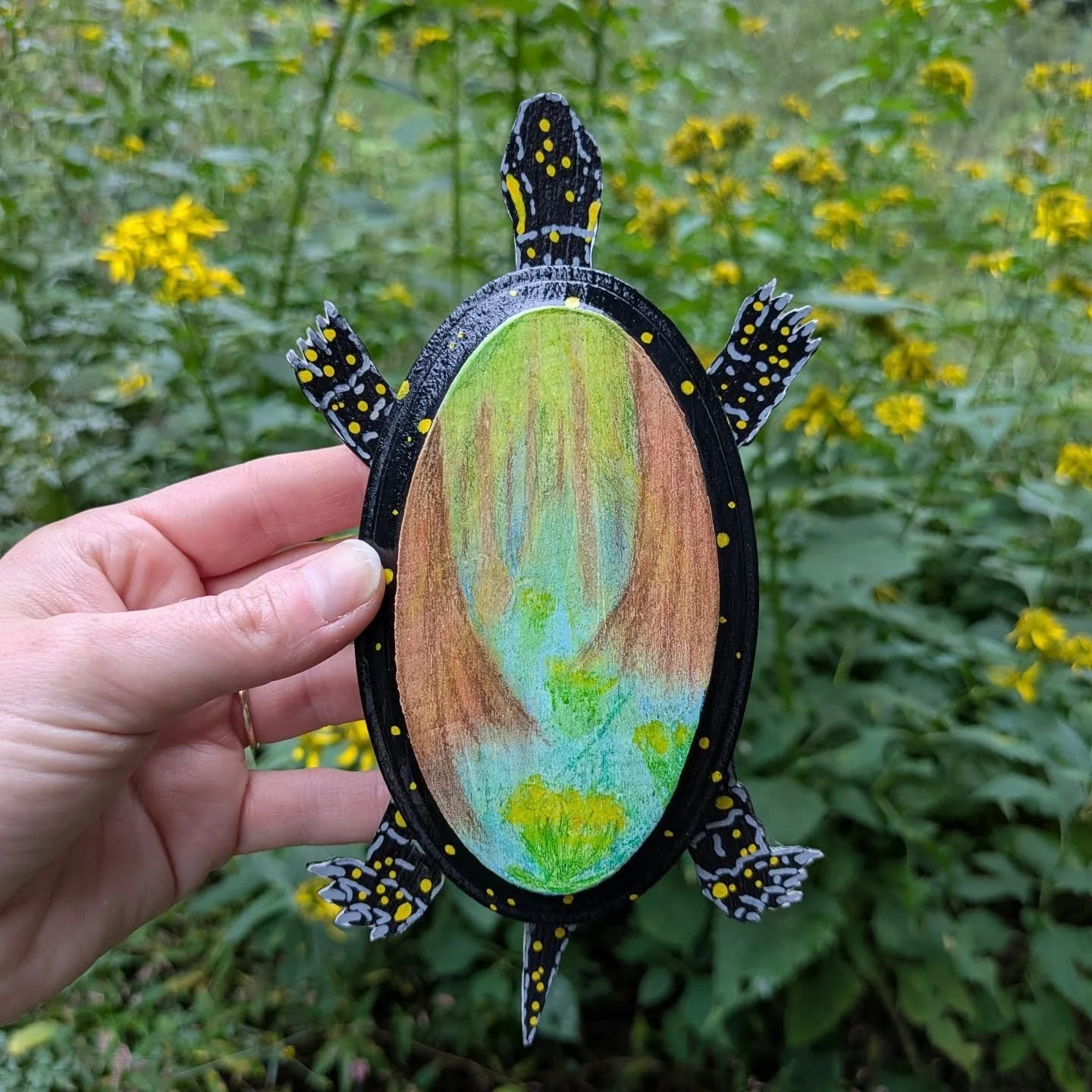 &quot;I carry the world on my shoulders.&quot; 2025
 Mixed Media-Paint pen, pastel, on wood and card stock. 
...
While creating this piece I was inspired by the precious spotted turtles I would see at Congaree National Park and the ones I worked with