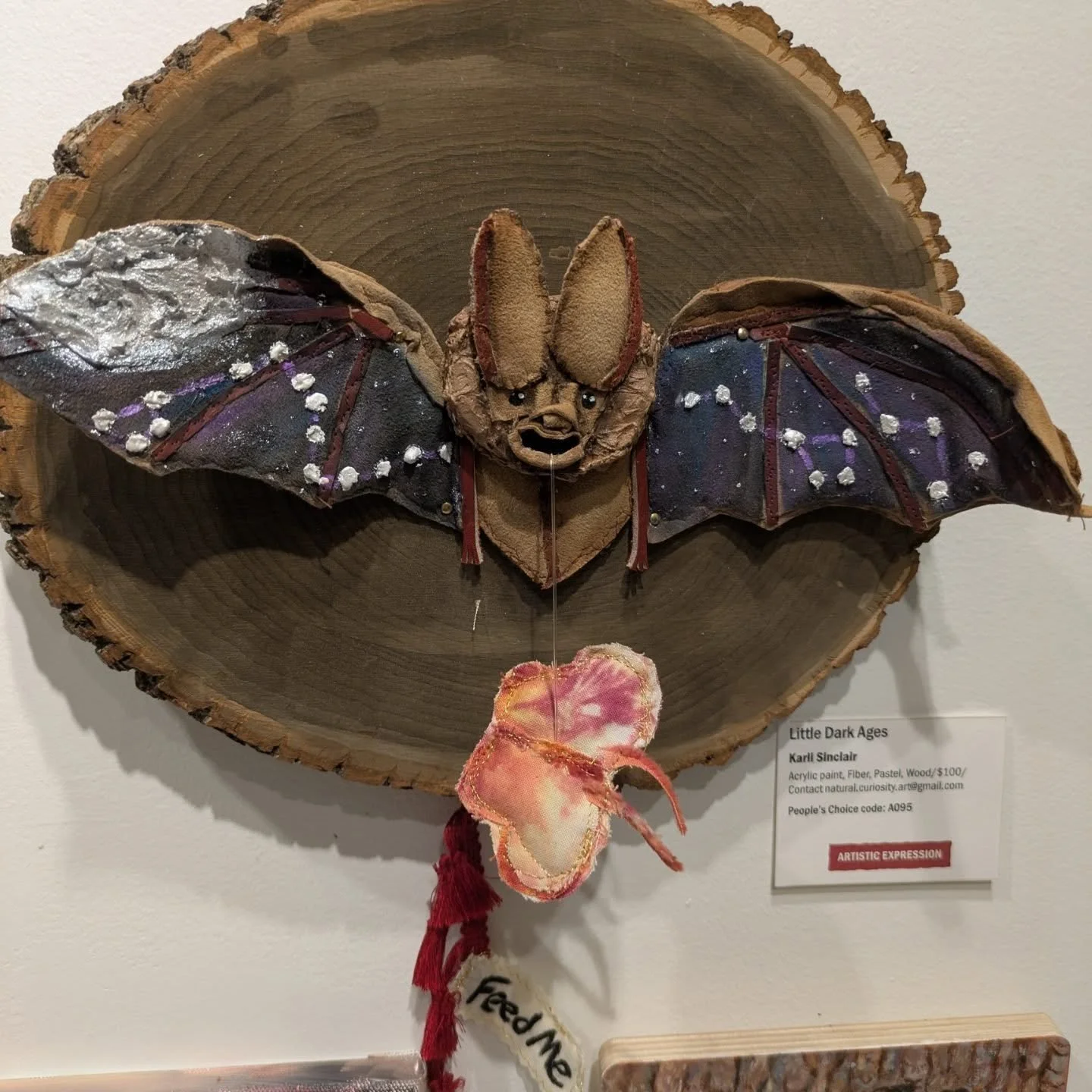 Only a few more days to check out my piece "Little Dark Ages" along with all of the other wonderful bat art. 
...
My piece was made with all recycled and reused materials. The colorful moth represents finding the light in darkness and fueli