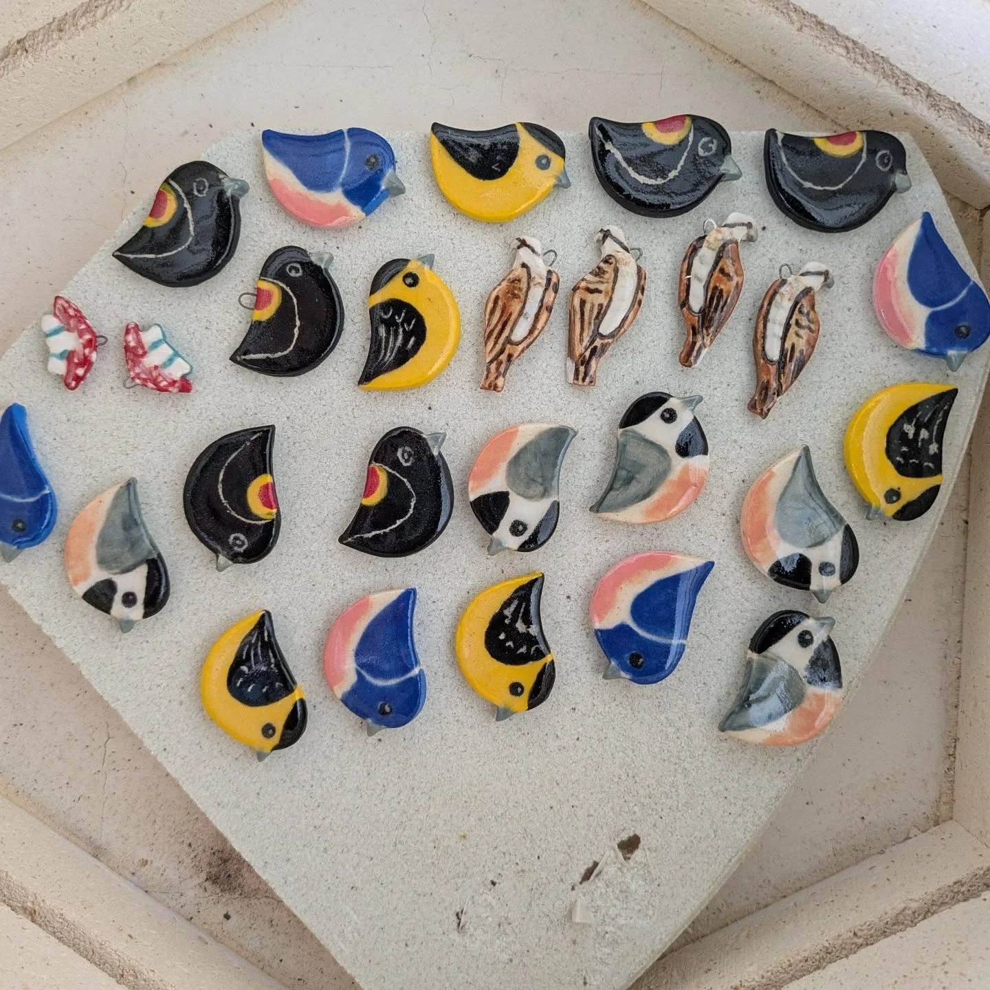 Fresh out of the kiln and looking BEAUTIFUL! 
🐦My bird pins can be found @scrap_rva in the @heydiscobunny vending machine. 
🐟One pair of osprey earrings will be on Etsy.
🍄 The mushroom earrings will be a part of a scavenger hunt in June. @gameofsh