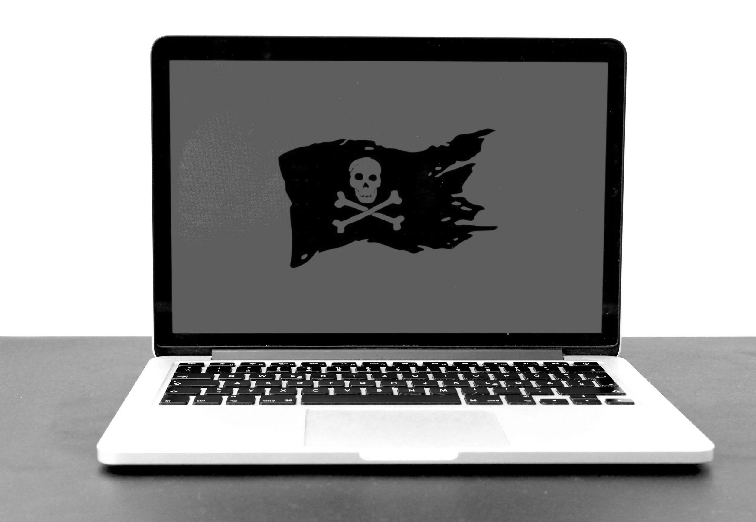 Laptop computer displaying a pirate flag with a skull and crossbones.