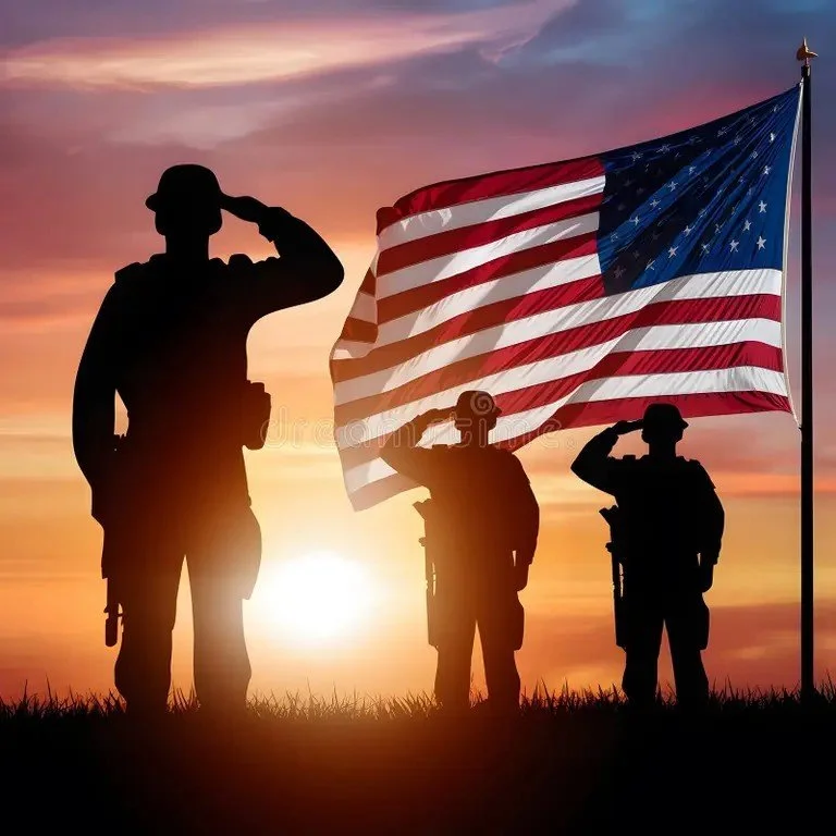 Silhouettes of three soldiers saluting next to American flag at sunset.