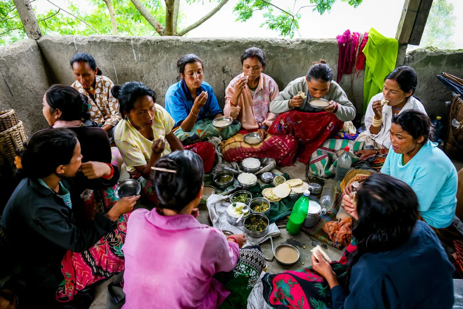Tea garden workers take a break and share food together.