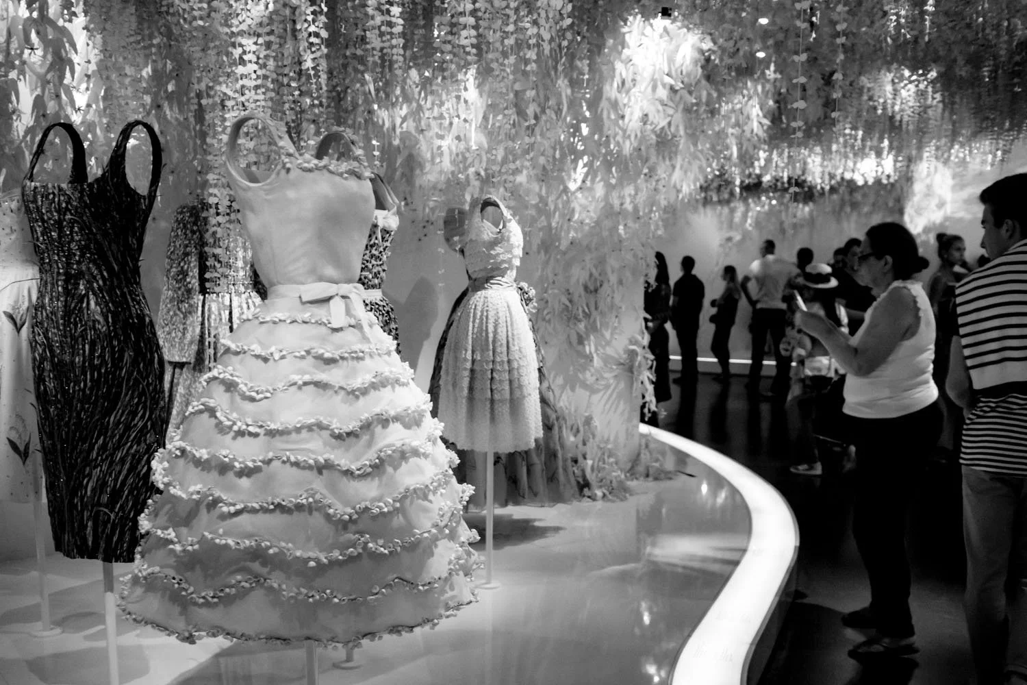 Visitors quietly observe and photograph Dior couture, where fashion continues its dialogue with a contemporary audience.