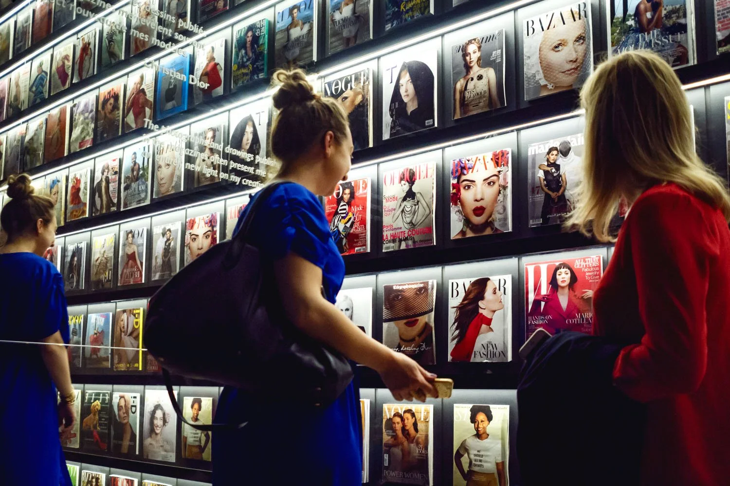 A quiet moment in the gallery where printed fashion history becomes part of the exhibition experience.