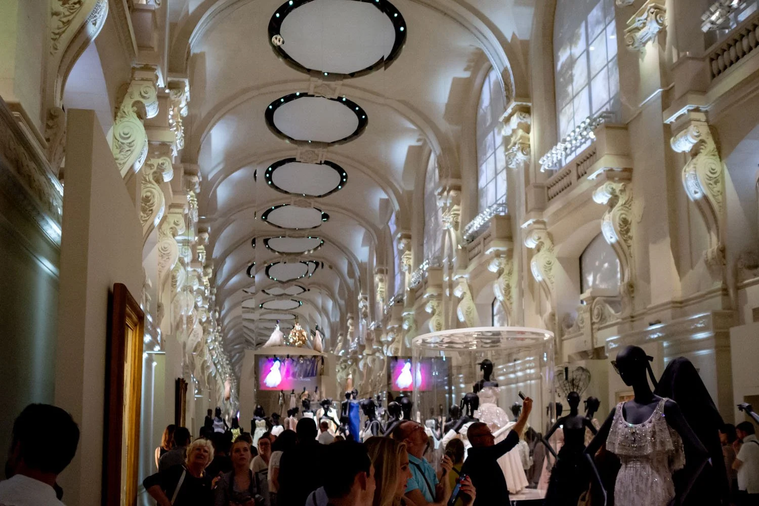 The monumental Dior hall where fashion, cinema, and exhibition design merge into a theatrical environment.