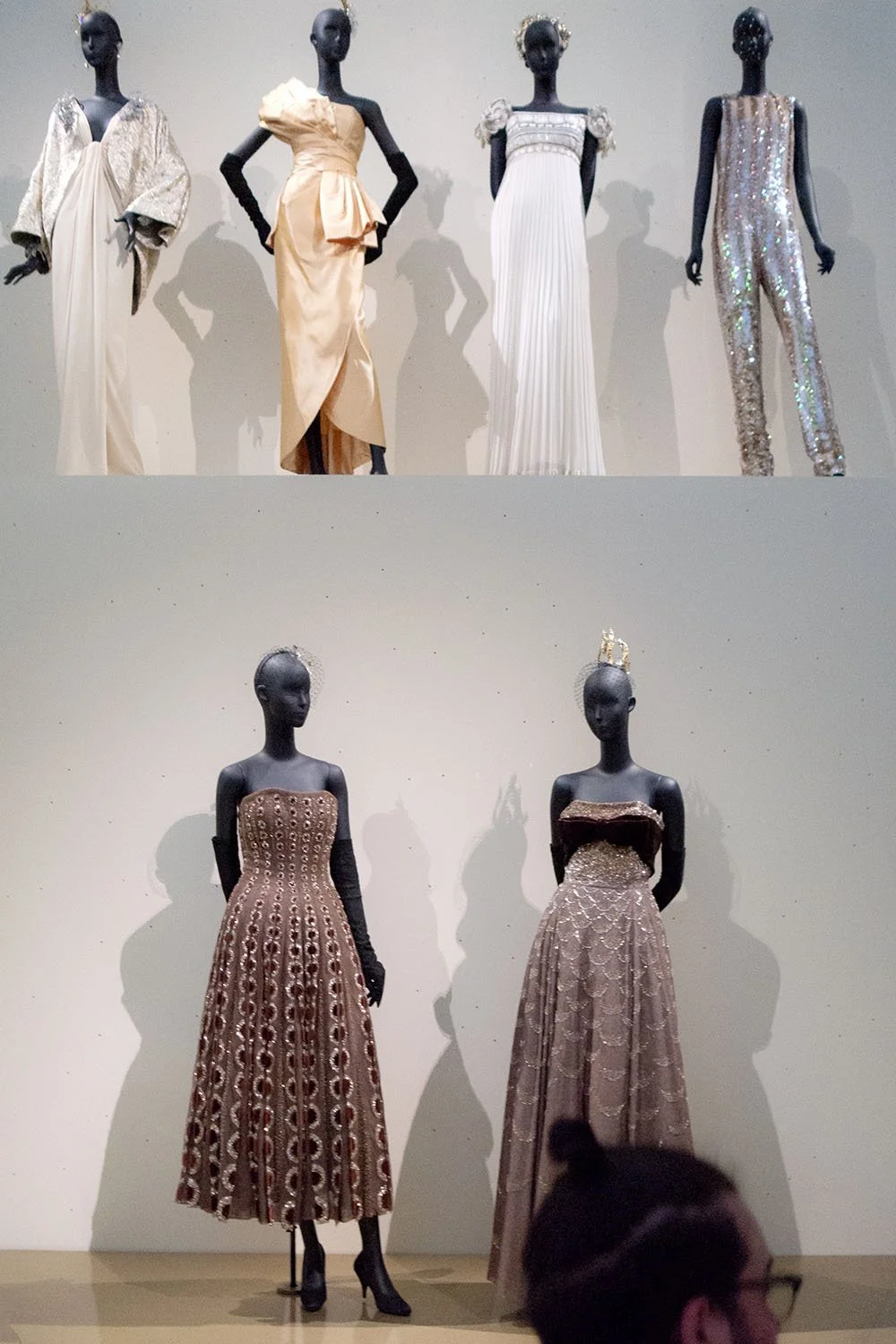 Dior silhouettes appear across two levels of display, revealing the evolution of form and craftsmanship within the house.