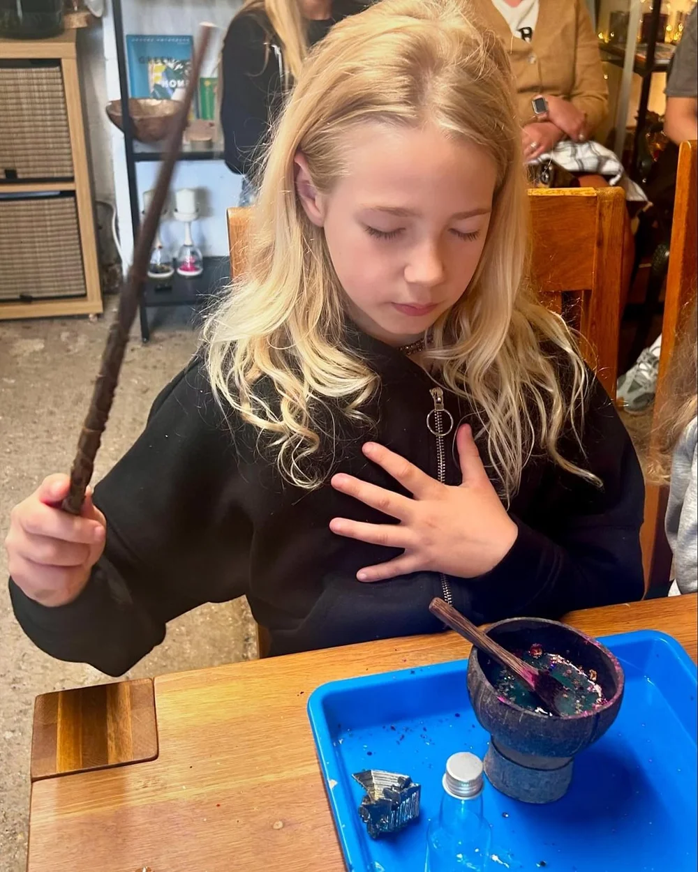 A girl making a wish over her potion