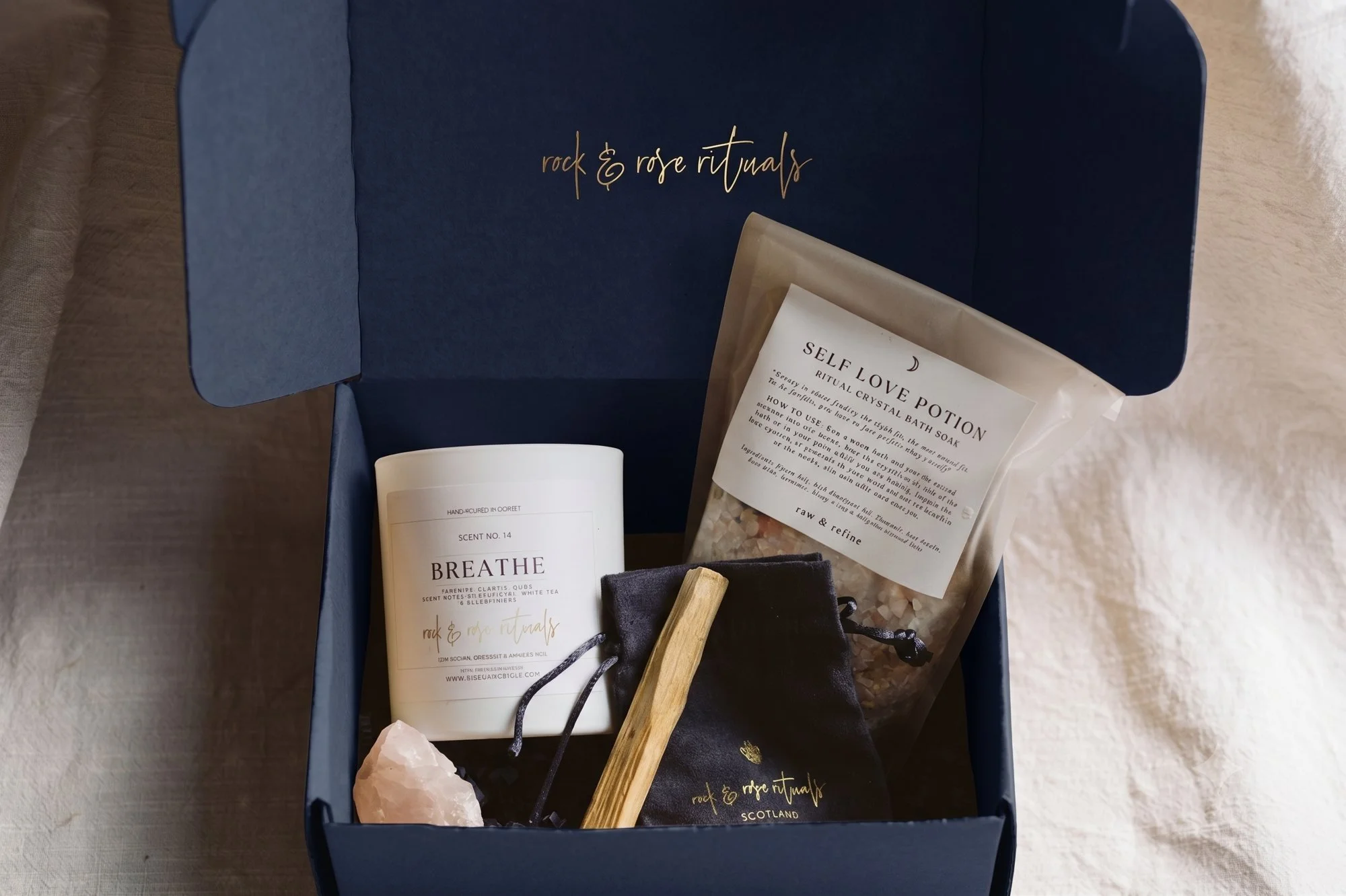 Full ritual bathing kit box with a Rock & Rose Rituals candle, Self Love Potion bath salts, rose quartz crystal and palo santo
