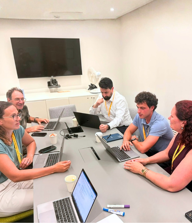 people in a meeting around a table talking to each other