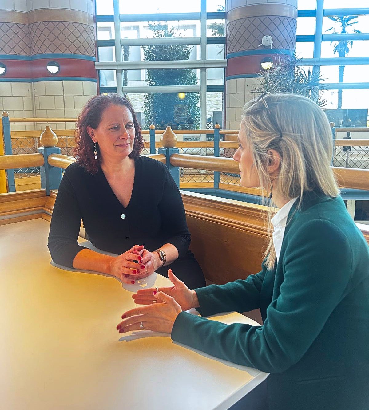 two women sitting in a meeting facing each other