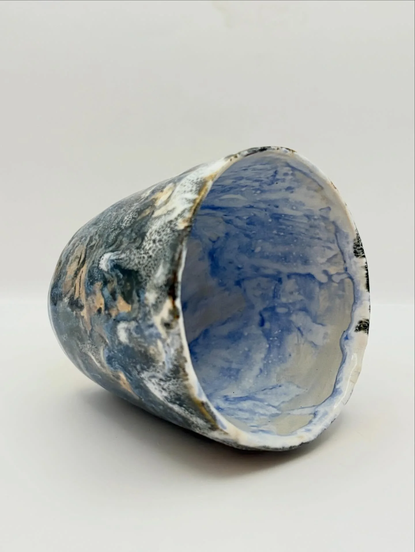 An assortment of pieces from the most recent batch, ready for upcoming events. 
1 &amp; 2: Cup thrown and textured by my partner, which I glazed.
3: Vase, kurinuki iterations.
4: Cup, kurinuki iterations; carved with my partner, alternating strokes.
