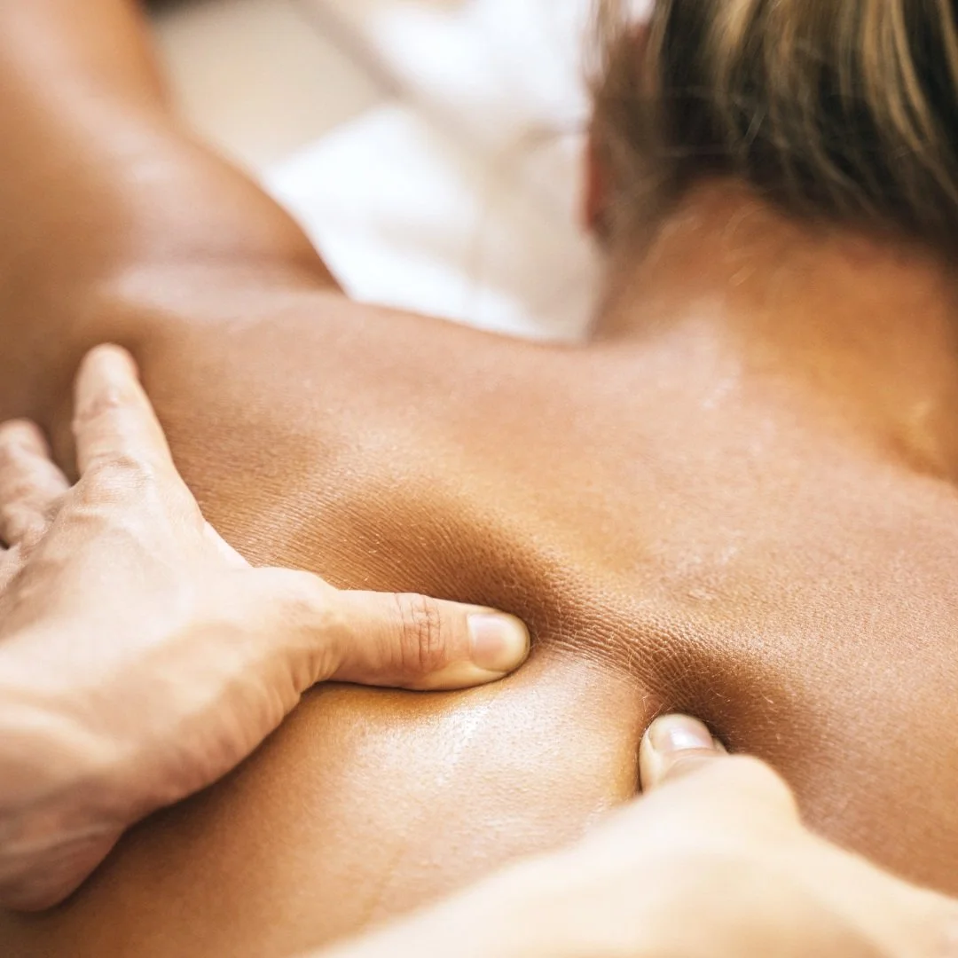 Person in Banbury receiving a back massage from Emily Ashburton, close-up of hands applying pressure on the upper back.