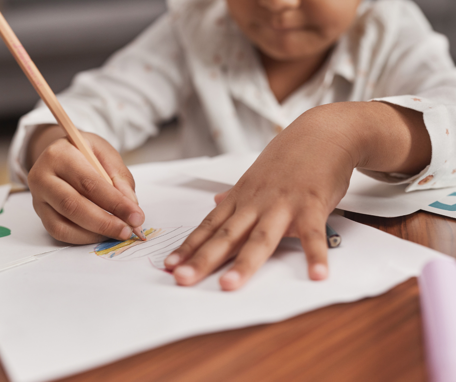 Child writing with a pencil.