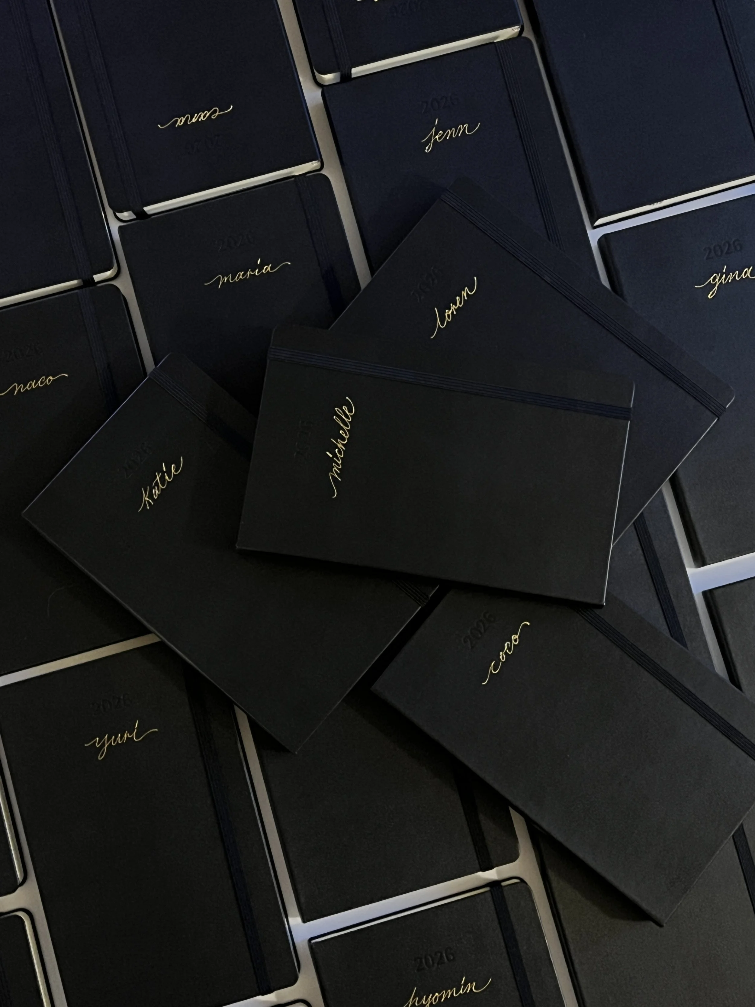 gold hot foiling on moleskine diary by LA-based calligrapher for luxury brand
