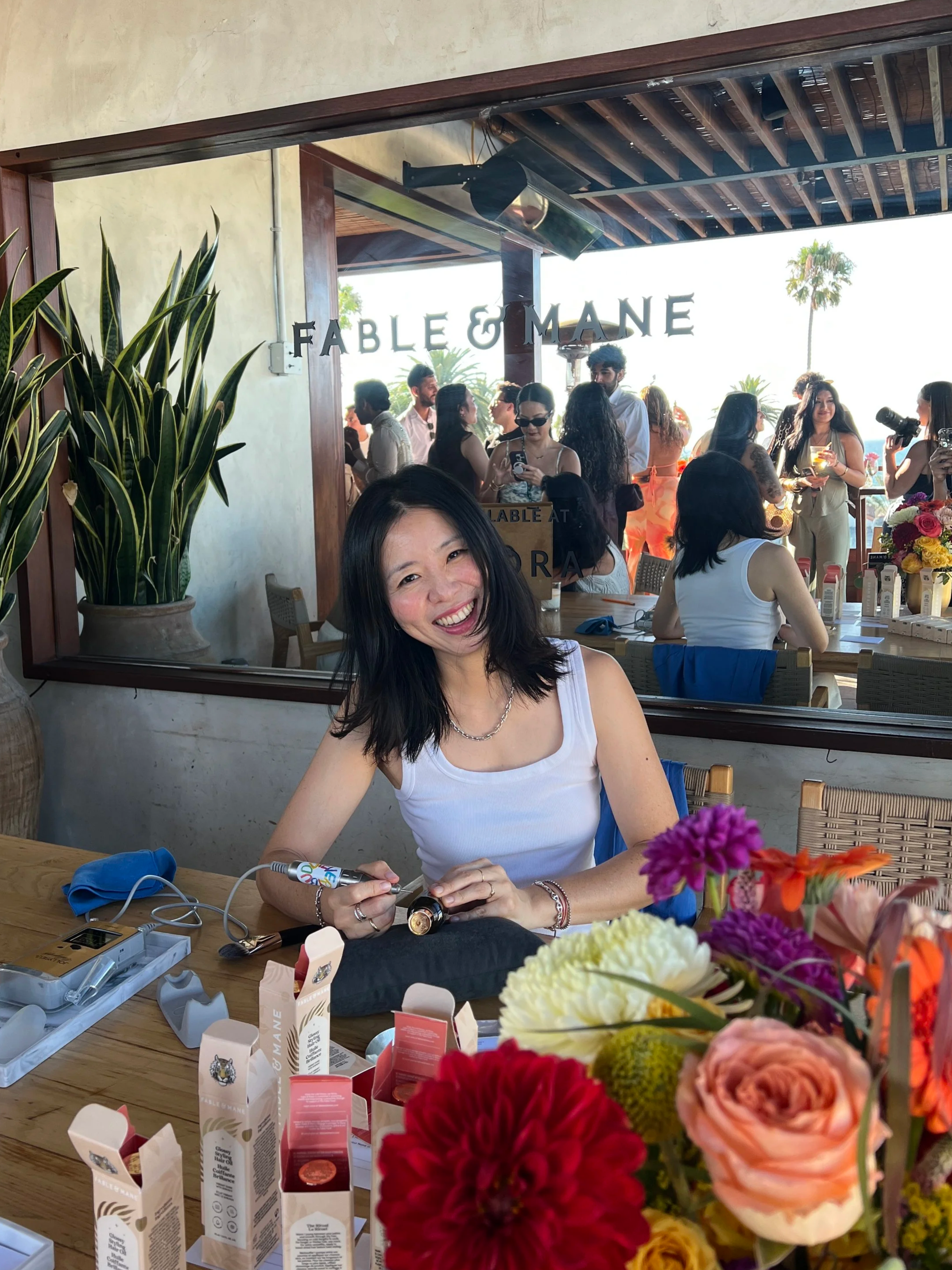 Los Angeles calligrapher Hanseul Kim providing live calligraphy and on-site personalization at a Beauty brand event.