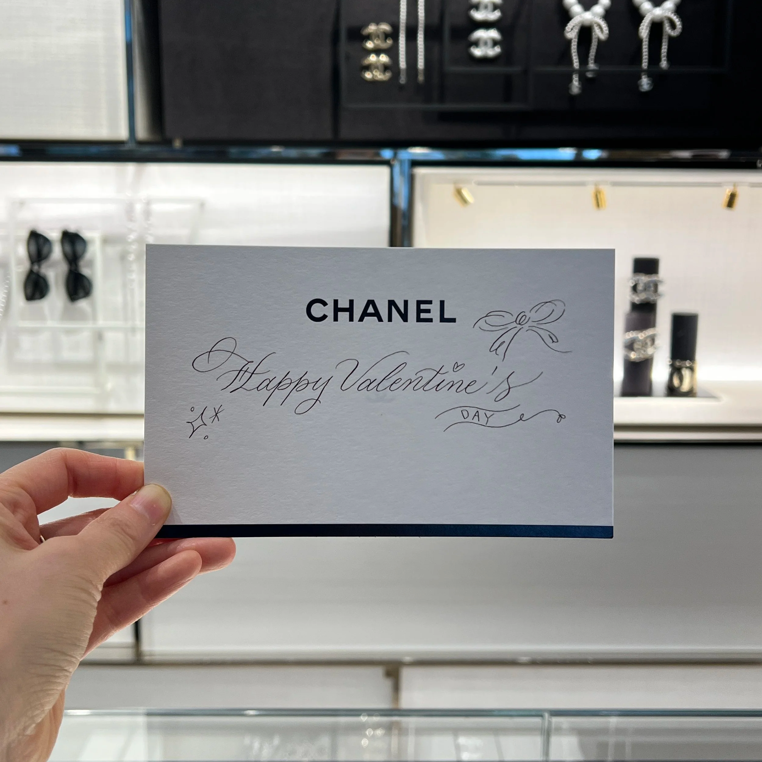 Hanseul Kim hand lettering at Chanel's Beverly Hills boutique during a Valentine's Day on-site calligraphy event