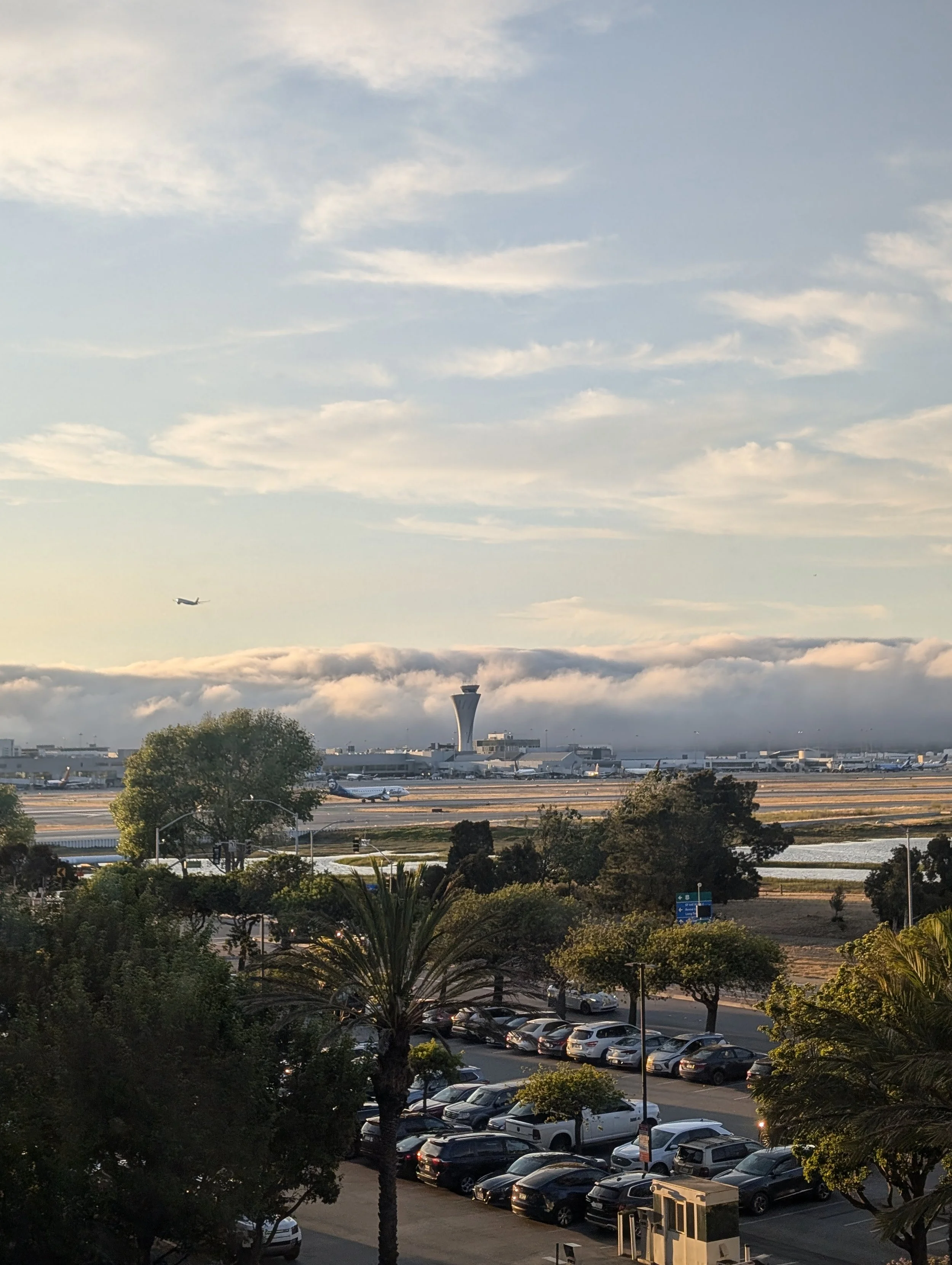 View of the SFO airport control tower and runways at sunset from a Westin San Francisco Airport hotel room