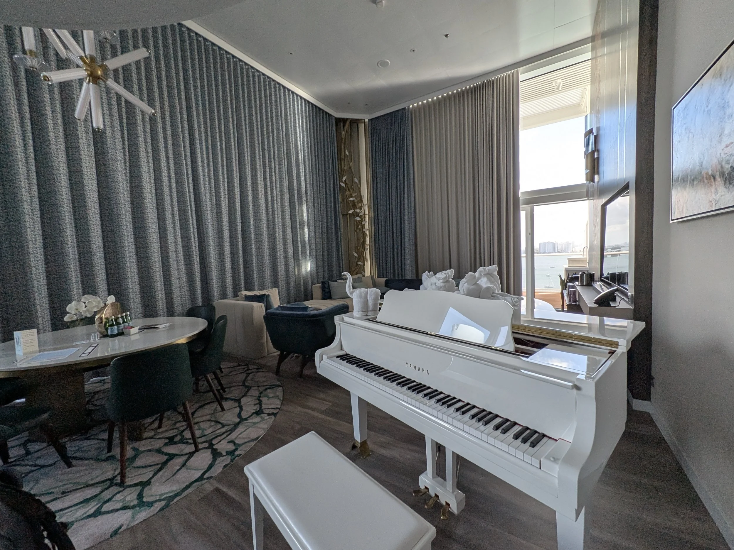 Royal Caribbean Star Class Royal Loft Suite living area with a white baby grand piano