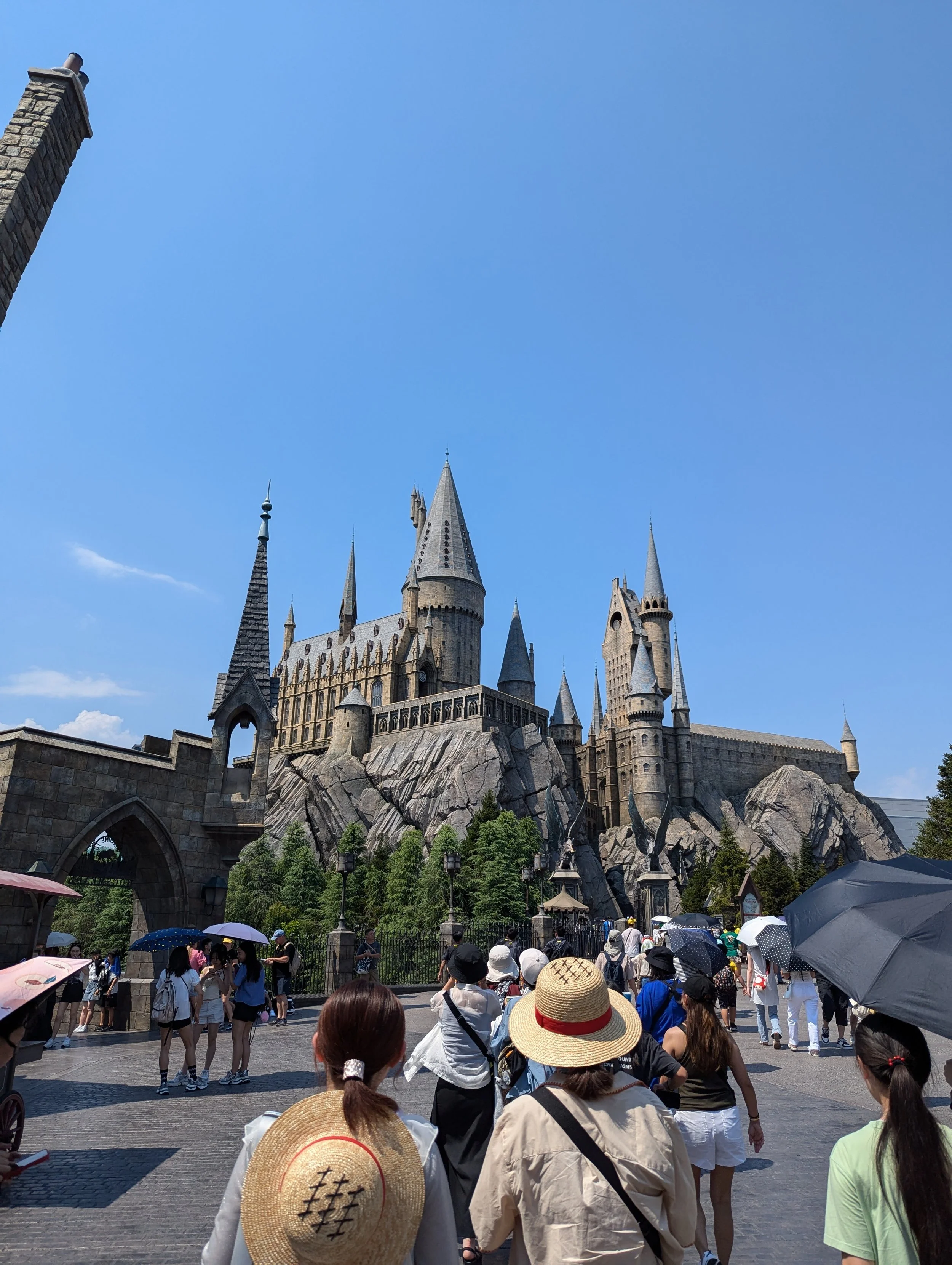Hogwarts Castle above Hogsmeade village in the Wizarding World of Harry Potter at Universal Studios Japan