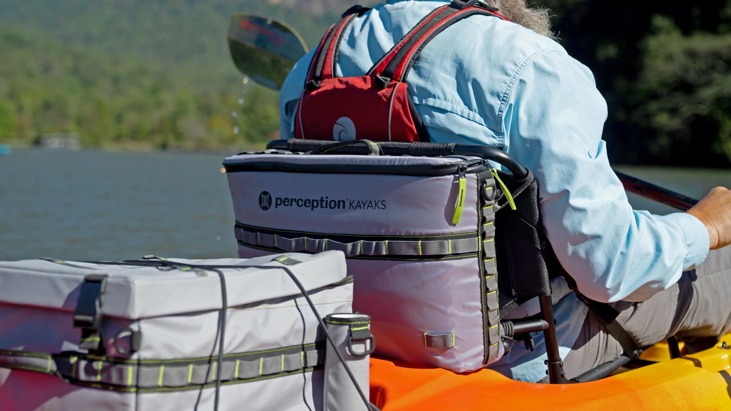 Image of man in kayak with Perception Splash Seatback Cooler and Kayak Crate.
