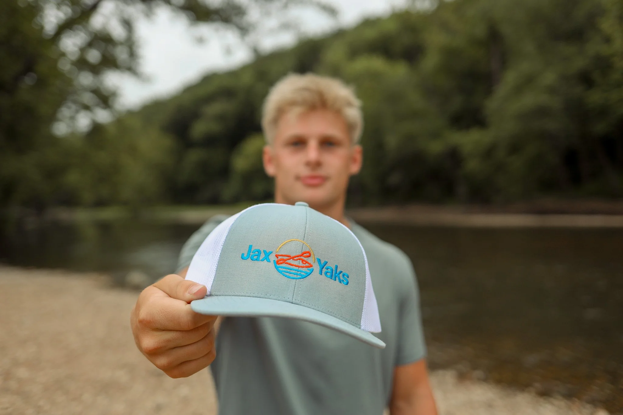 Founder Jax Glendenning holding a Jax Yaks branded hat.