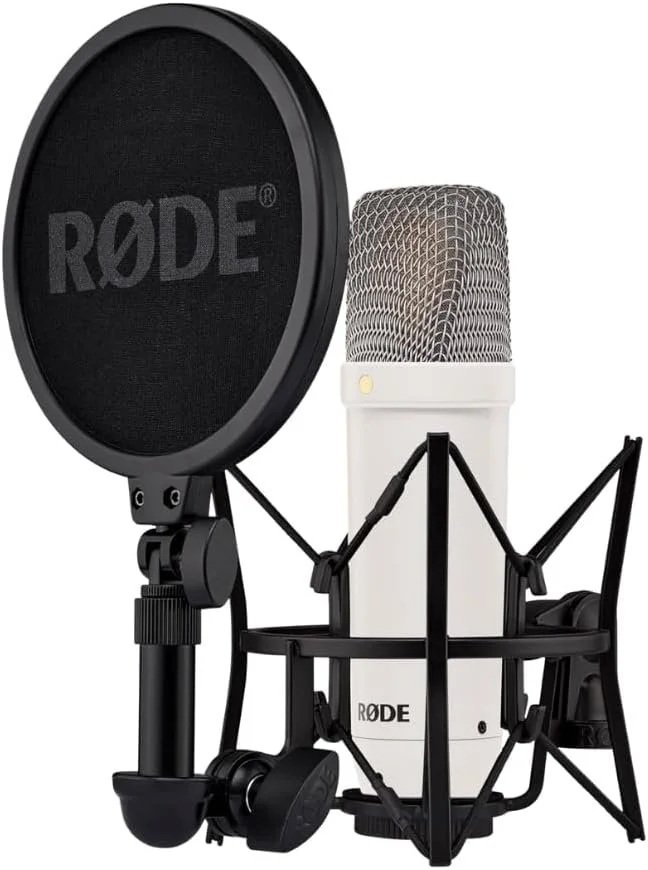 A recording setup with a RØDE microphone, pop filter, microphone shock mount, and headphones.