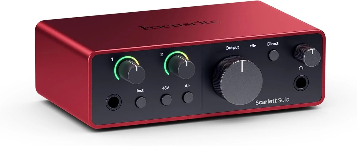 A red Focusrite Scarlett Solo audio interface with black knobs and input/output ports.
