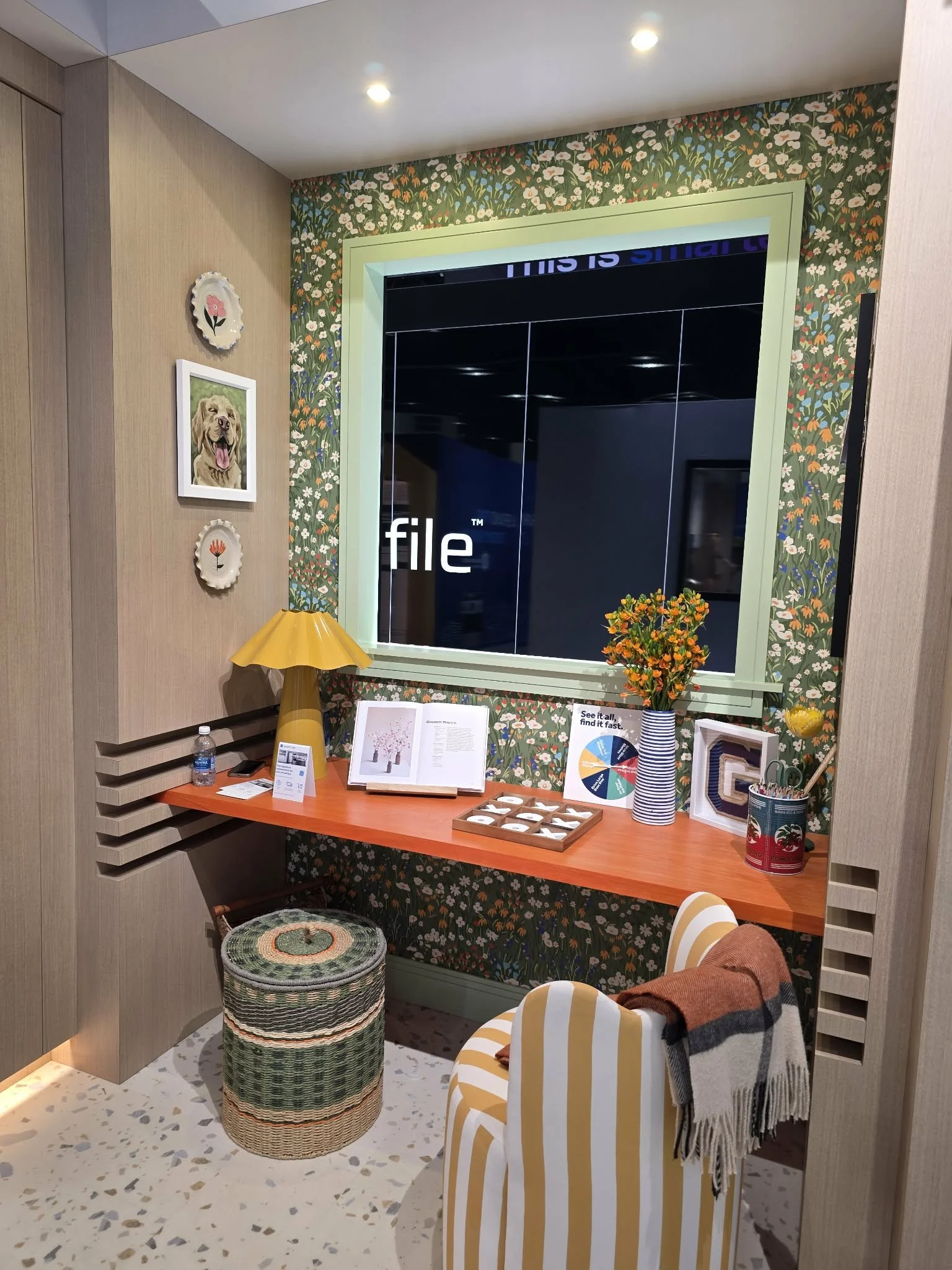 Bold floral wallpaper desk nook with orange floating desk, green trim, and layered warm tones from KBIS 2026 color trends.