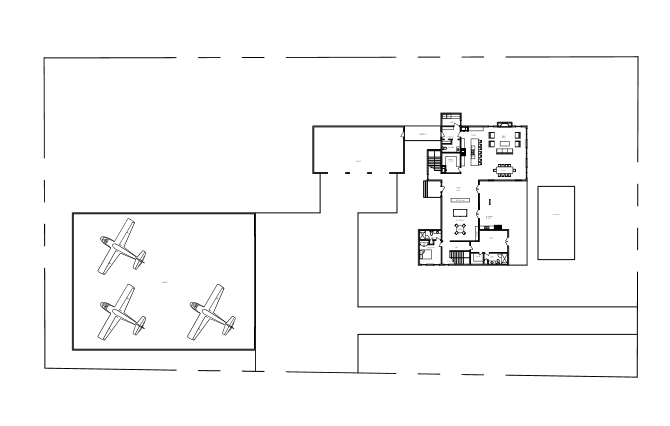 Floor plan layout of a property with a main building, an outdoor patio, and an area with three small planes or gliders.