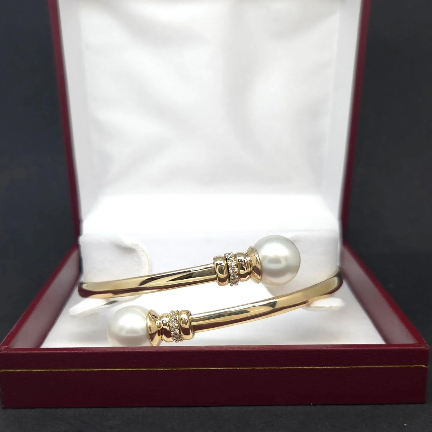 Two pearls. 24 diamonds. One-of-a-kind. 🕊️✨
​Handmade in solid 9k yellow gold, this bypass bangle is the definition of sophisticated sparkle. Those 13mm pearls are the stars of the show, complemented by 24 bead-set diamonds.
​Come see the brilliance