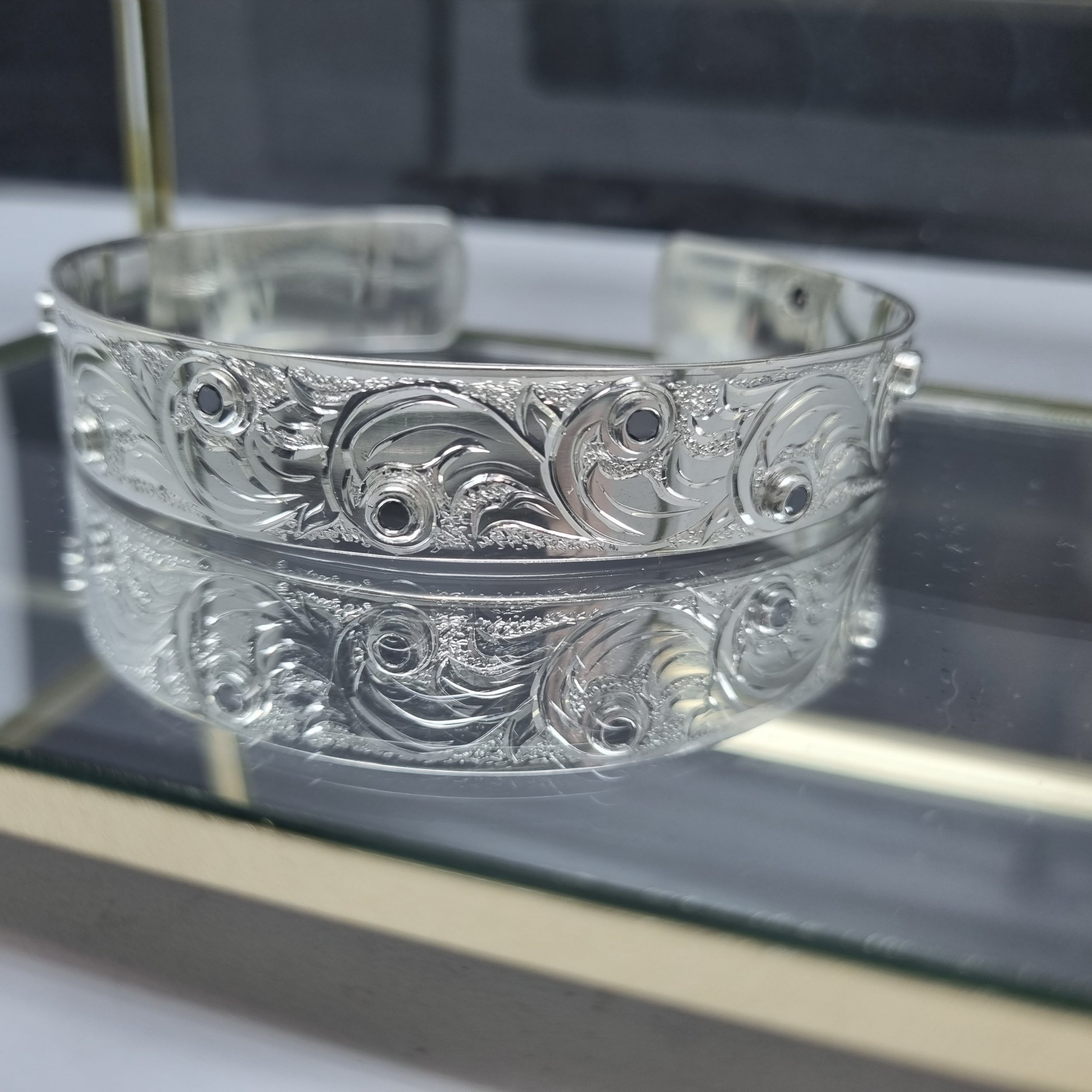Custom engraved silver bangle with black diamonds