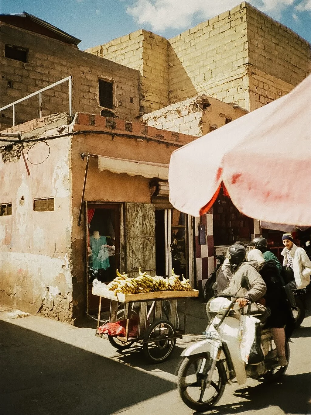 Late afternoon light and life in motion tucked in the corners and alleys of Marrakesh souks on #35mmfilm 🌀
