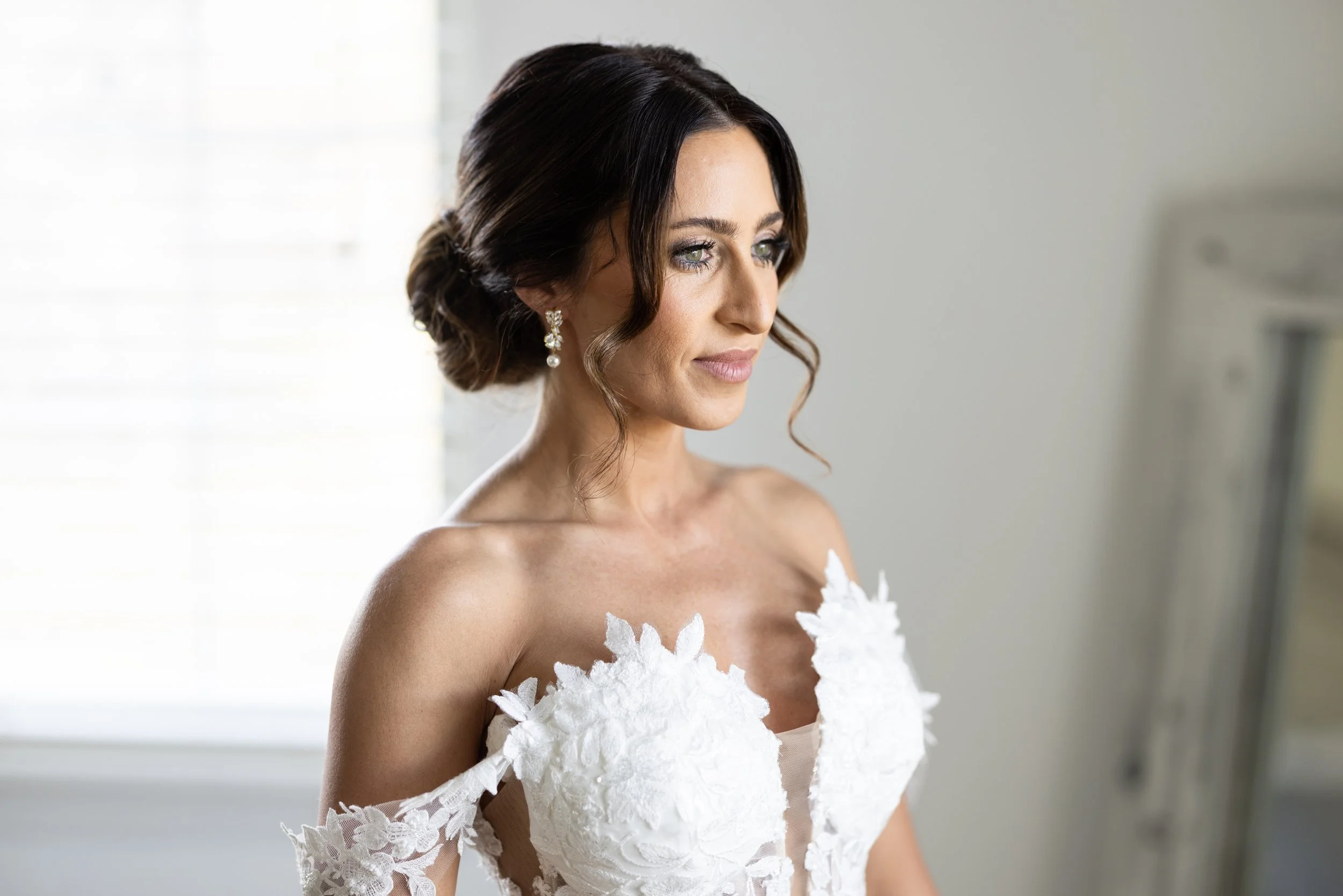 At her home, Dana, shines brightly with her loose, yet controlled upstyle for her wedding day.