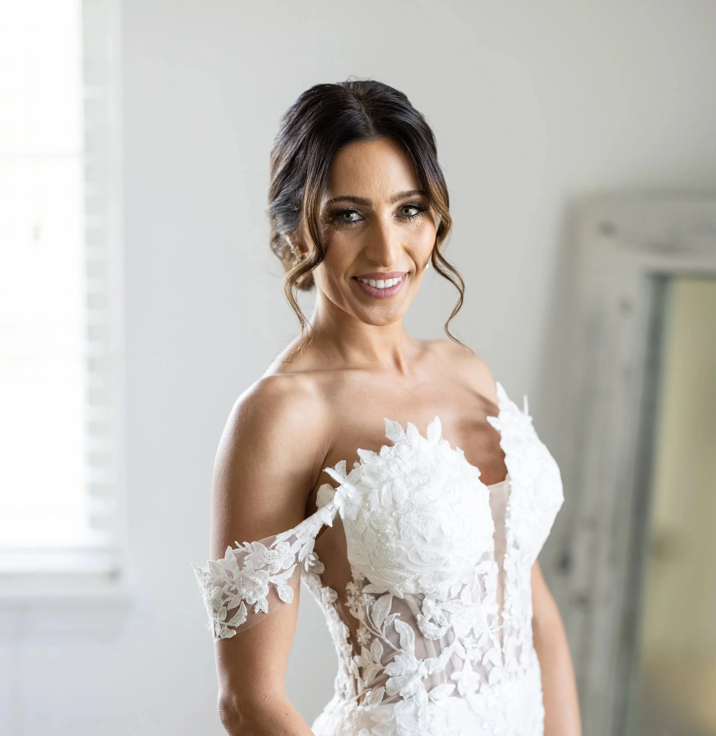 Person with hair all up in a messy, textured bun for a wedding. 