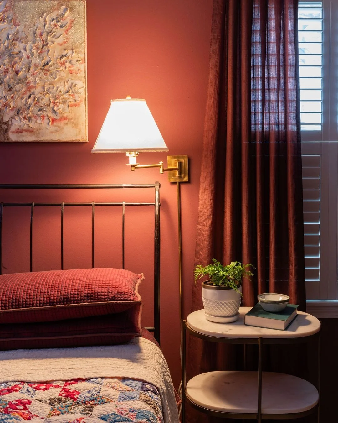 Color has so much personality.  Add in the soft glow of a wall sconce and an antique-inspired mirror, and this East Memphis bedroom feels like a warm drink by the fire. 
📷 @stefanie_rawlinson_photo #memphisinteriordesign #sherwinwilliamspaint #red #