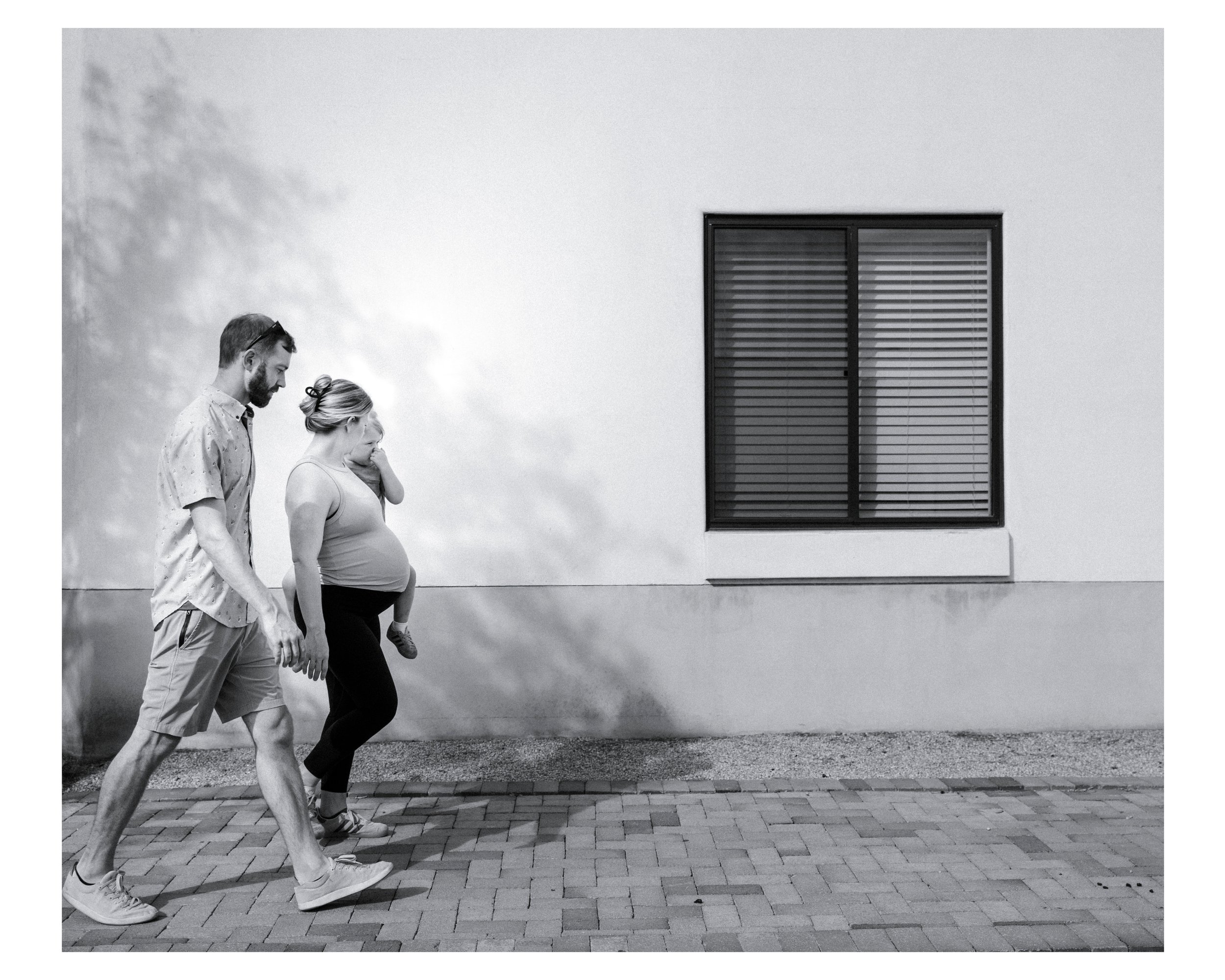 family walks in the neighborhood during a family documentary session in tucson