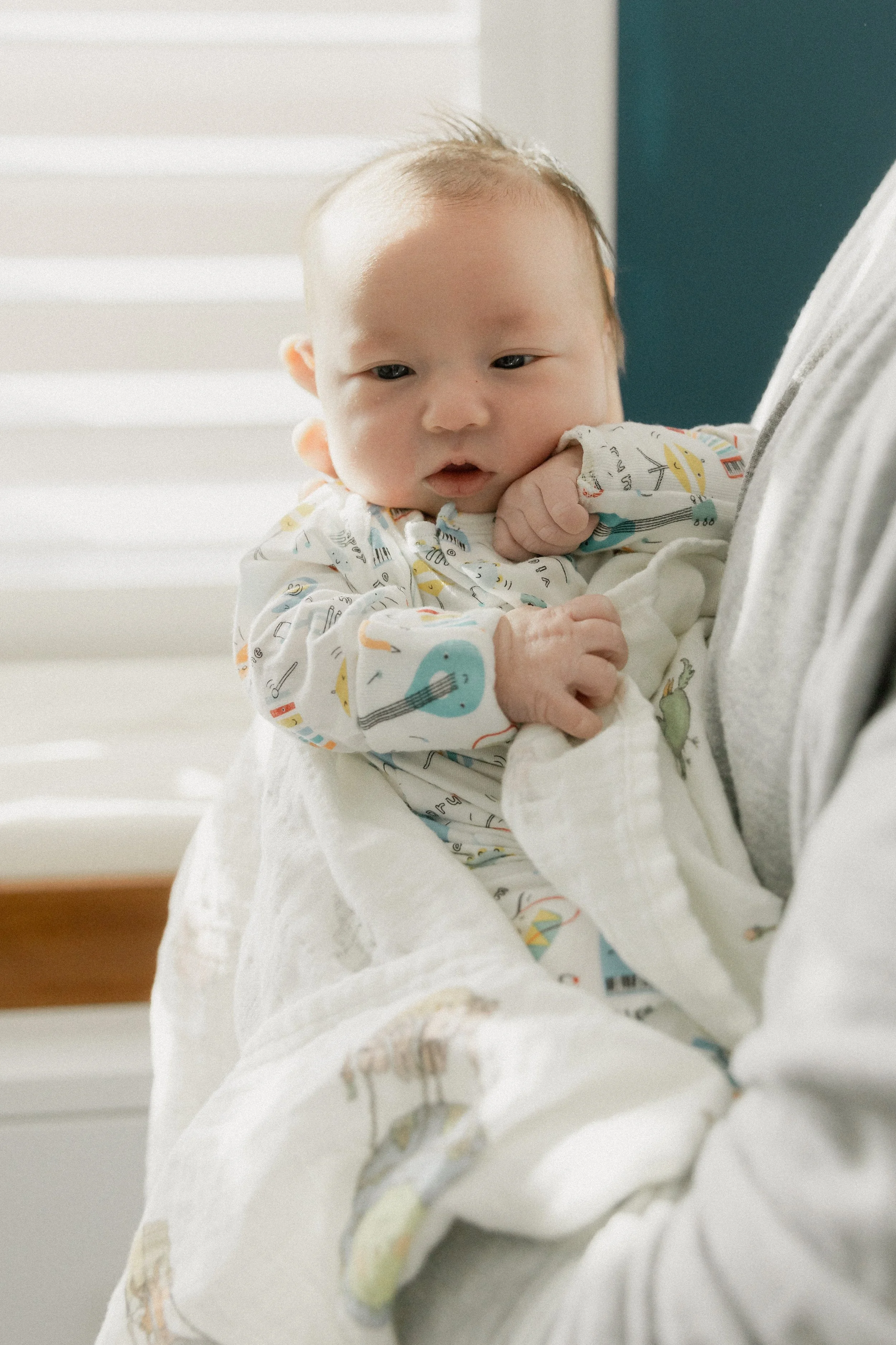 newborn propped up by dad