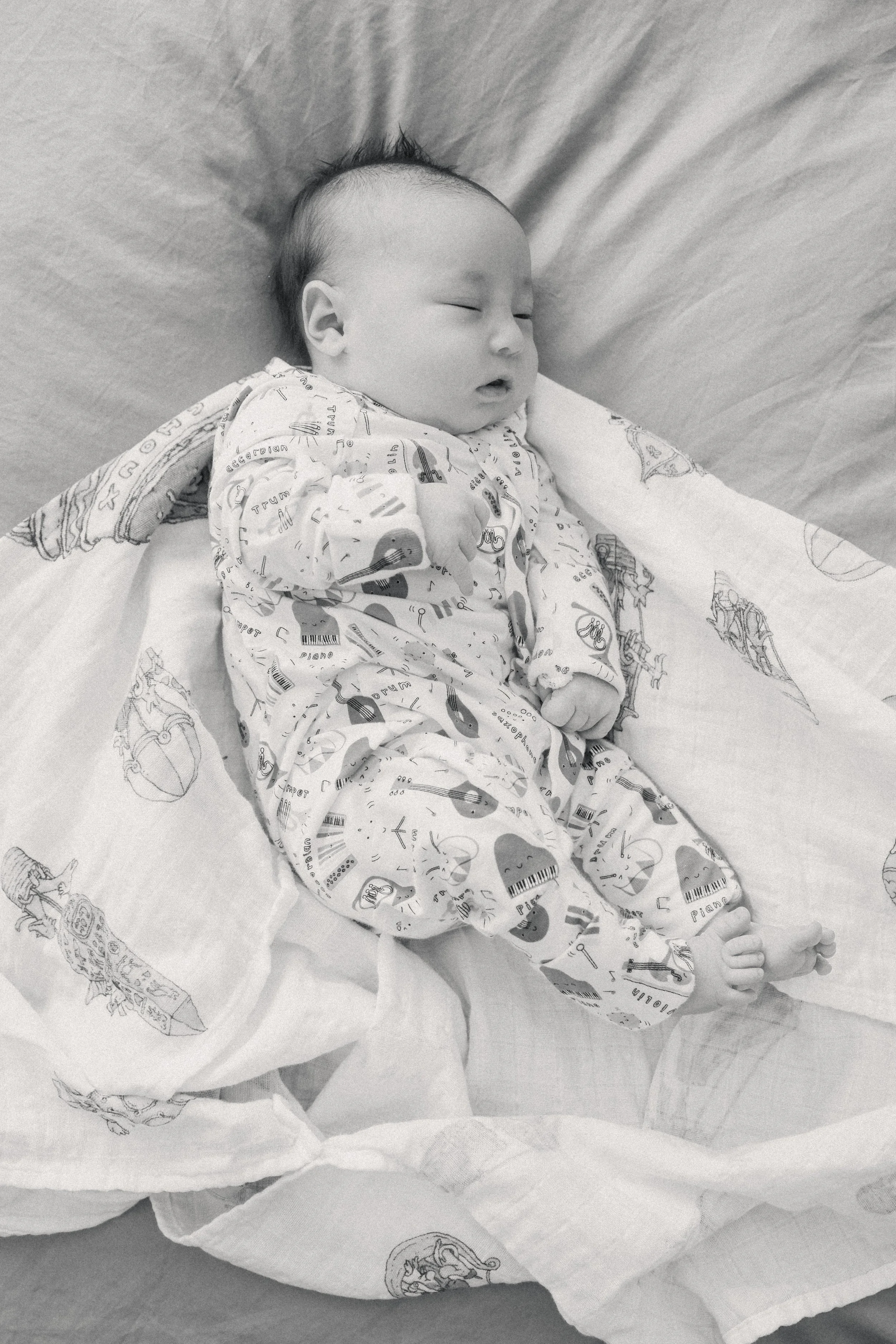 newborn baby sleeps during photos with newborn photographer